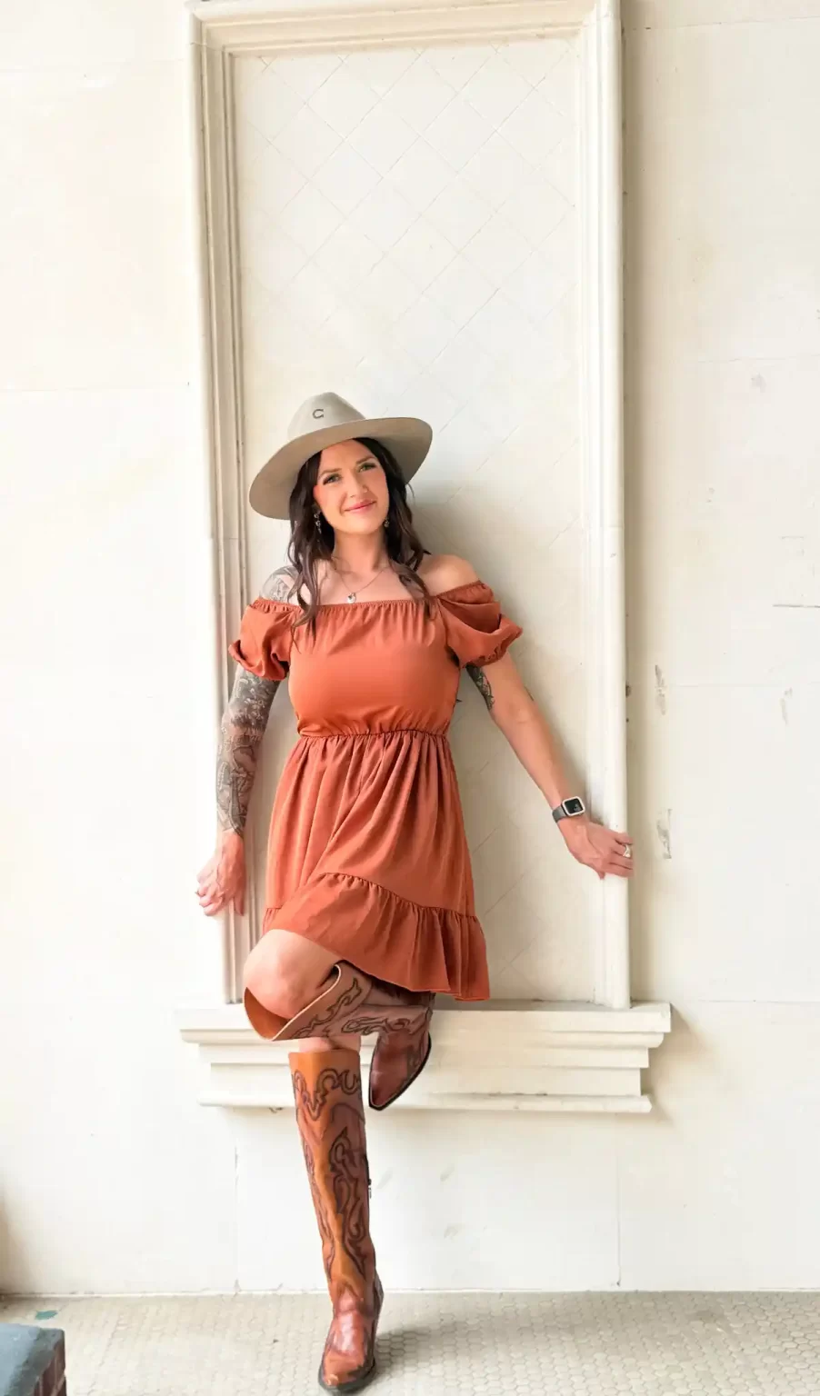 Owner posing outside the Remedy Aesthetics and Wellness building